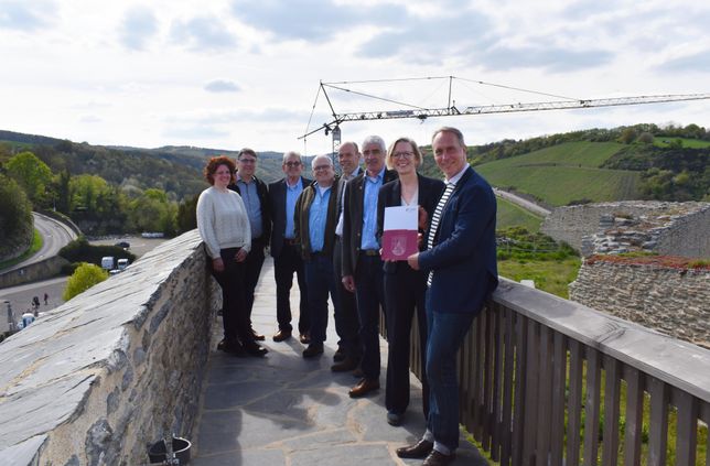 Staatssekretärin Simone Schneider übergab Bürgermeister Falko Hönisch (vorne) kürzlich den neuen Förderbescheid auf Burg Rheinfels auf der hohen Batterie.