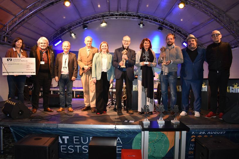 Foto1 (v.l.): Petra Orlich-Kasper, Thomas Duttenhoefer, Bürgermeister Dr. Andreas Nikolay, Ulrich Tukur, Kulturministerin Katharina Binz, Edgar Reitz, Bettina Borgfeld, York-Fabian Raabe, Festspielleiter Urs Spörri und Wolfgang Stemann. (Fotos: Andreas Bender / Lena Ruzicka / Karl Apsel; Video: Bender)