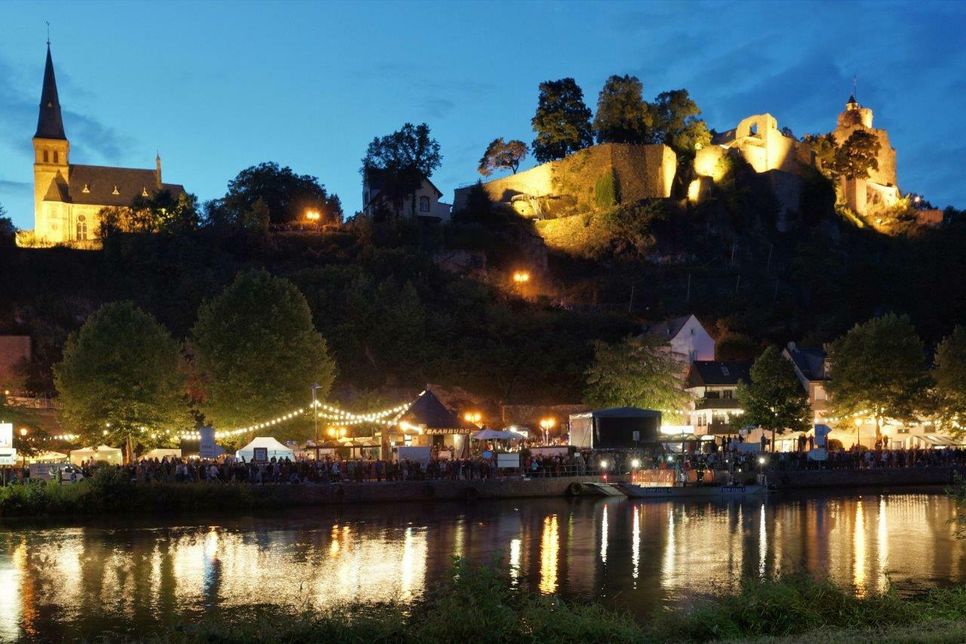 Abendliches Panorama mit Blick auf Saar, Burg sowie das Saarweinfest am Fuße des Burgberges. Das Fest findet vom 1. bis 3. September statt. Foto: Ulrich Schmidt