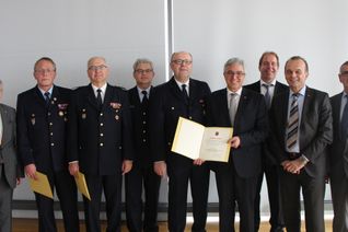 Hans-Werner Thomas (2. vl.) wurde mit dem Goldenen Feuerwehr-Ehrenzeichen als Steckkreuz ausgezeichnet. Zu den ersten Gratulanten zählte Landrat Manfred Schnur (links).