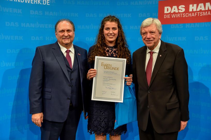 Hans Peter Wollseifer (l.) und Volker Bouffier (r.) überreichten Lena Lamberty die Ehrenurkunde. Foto: Rüdiger Jeske