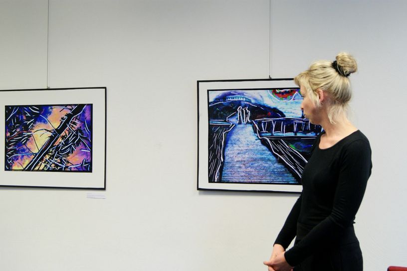 Am Anfang der Vernissage erklärte Stefanie Manhillen die Machart ihrer Bilder und die Motivation die dahintersteckt. Foto: Woltmann
