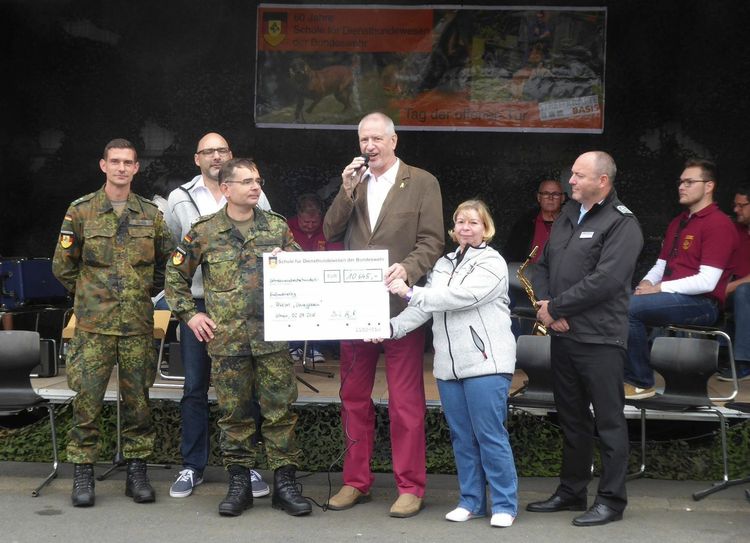 Der Kommandeur der Diensthundeschule, Oberfeldveterinär Dr. Stefan Hampel, übergibt den Scheck in Höhe von 10.645 Euro an Hauptmann a. D. Uwe Sander vom Bundeswehrsozialwerk.