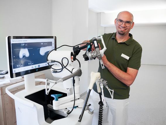 Dr. med. Elmar Schwarz, Chefarzt des Zentrums für Orthopädie und Unfallchirurgie am Klinikum Mutterhaus, mit dem für Knie-OPs verwendeten Robotersystem VELYS.