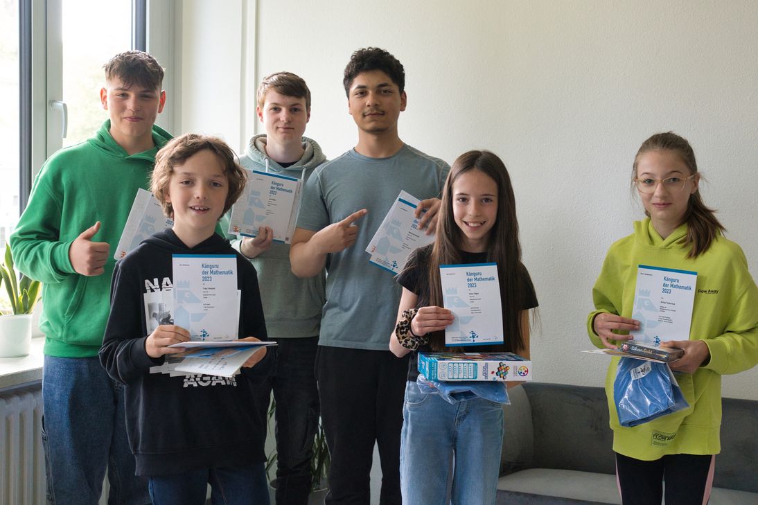 Die erfolgreichen Känguru-Teilnehmer/innen präsentieren ihre Urkunden und Preise.