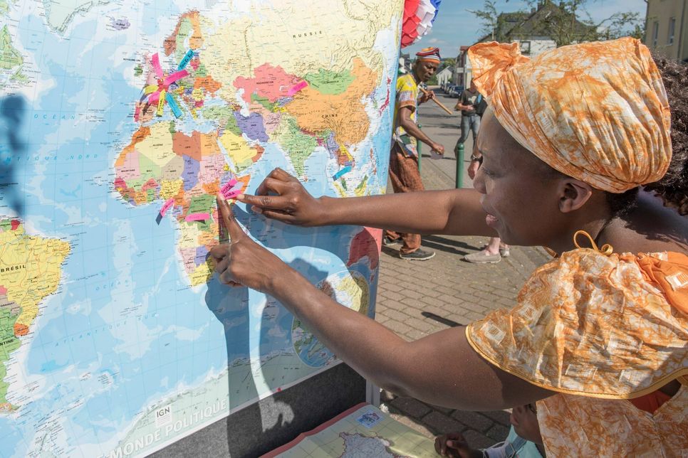 Auf einer großen Landkarte konnten die Menschen, wie hier Susan Nalwanga zeigen, aus welchem Land sie stammen.