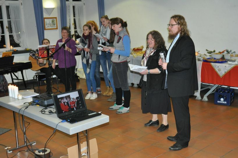 Diakon Michael Przesang und Hiltrud Weiler vom Netzwerk "Chancen für Flüchtlinge - Von Mensch zu Mensch" der Pfarreiengemeinschaft Kaisersesch und ein Chor junger Frauen und Mädchen, der sich spontan für das Begegnungsfest zusammengefunden hatte.