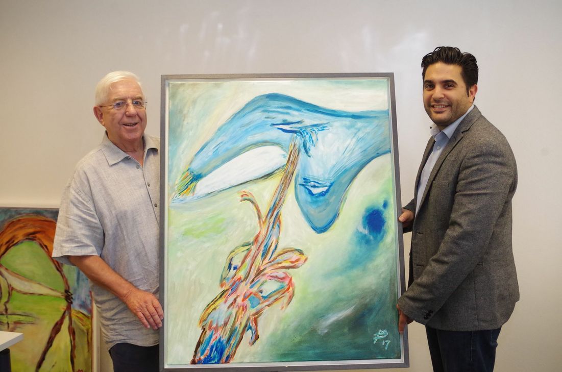 Die Bilder von Manfred Pusch (l.) hängen nun im Verlagsbüro des WochenSpiegels. Geschäftsstellenleiter Serkan Basar freut sich, den Besuchern wieder eine interessante Ausstellung präsentieren zu können. Foto: Mager