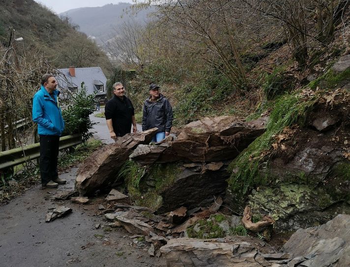 Christoph Pappert vom Landesamt für Geologie und Bergbau (LGB) und die Ortsbeigeordneten Christian Weber und Elmar Leyendecker am Felsrutsch im Katteneser Mühlental.