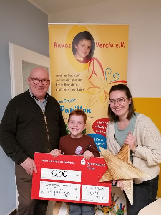 Stolz überreicht der Grundschüler Josef seine Spende in Höhe von 1.200 Euro an die "Beratungsstelle Papilllon Trier - für Kinder krebskranker Eltern", die er mit eigens hergestellten Holzsternen zusammengetragen hatte.