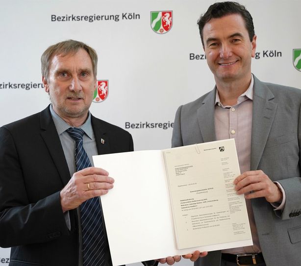 Aus den Händen des Kölner Regierungspräsidenten Dr. Thomas Wilk (r.) konnte der Kämmerer der Stadt Zülpich, Ottmar Voigt, den Zuwendungswendungsbescheid entgegennehmen. 
Foto: Bezirksregierung Köln