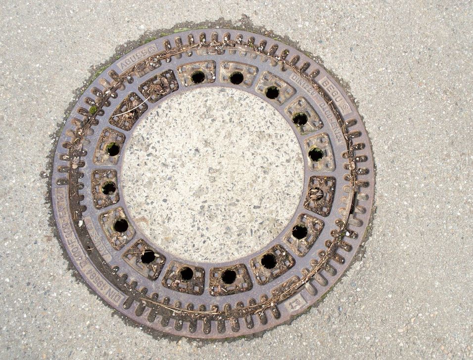 Ein Schneeräumfahrzeug ist in einen Kanalschacht gefahren, da der Kanaldeckel ausgehoben war.