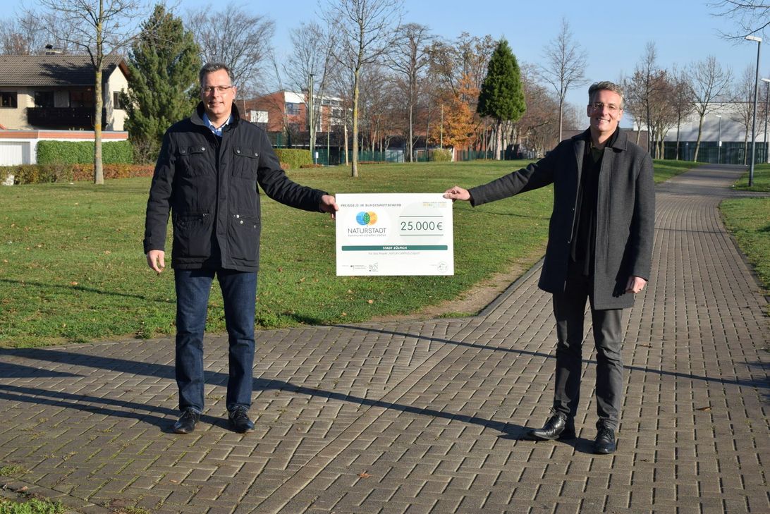 Freuen sich über den Scheck für das Projekt Natur-Campus: Bürgermeister Ulf Hürtgen und Geschäftsbereichsleiter Christoph M. Hartmann. 	Foto: Stadt Zülpich | Julia Schneider